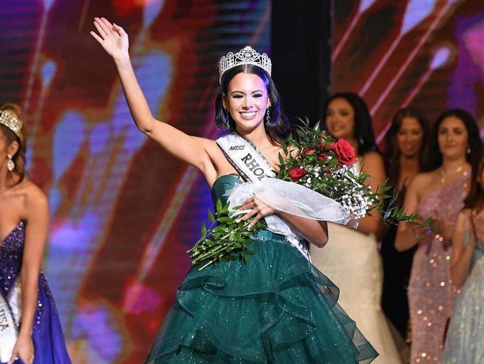 Model wearing a green dress with crown on head